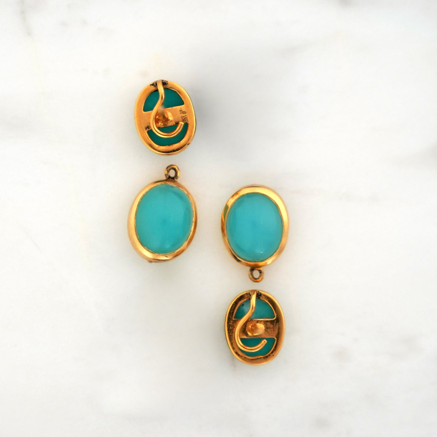 Amazonite and chalcedony blue gemstone earrings set in yellow gold on a light gray background