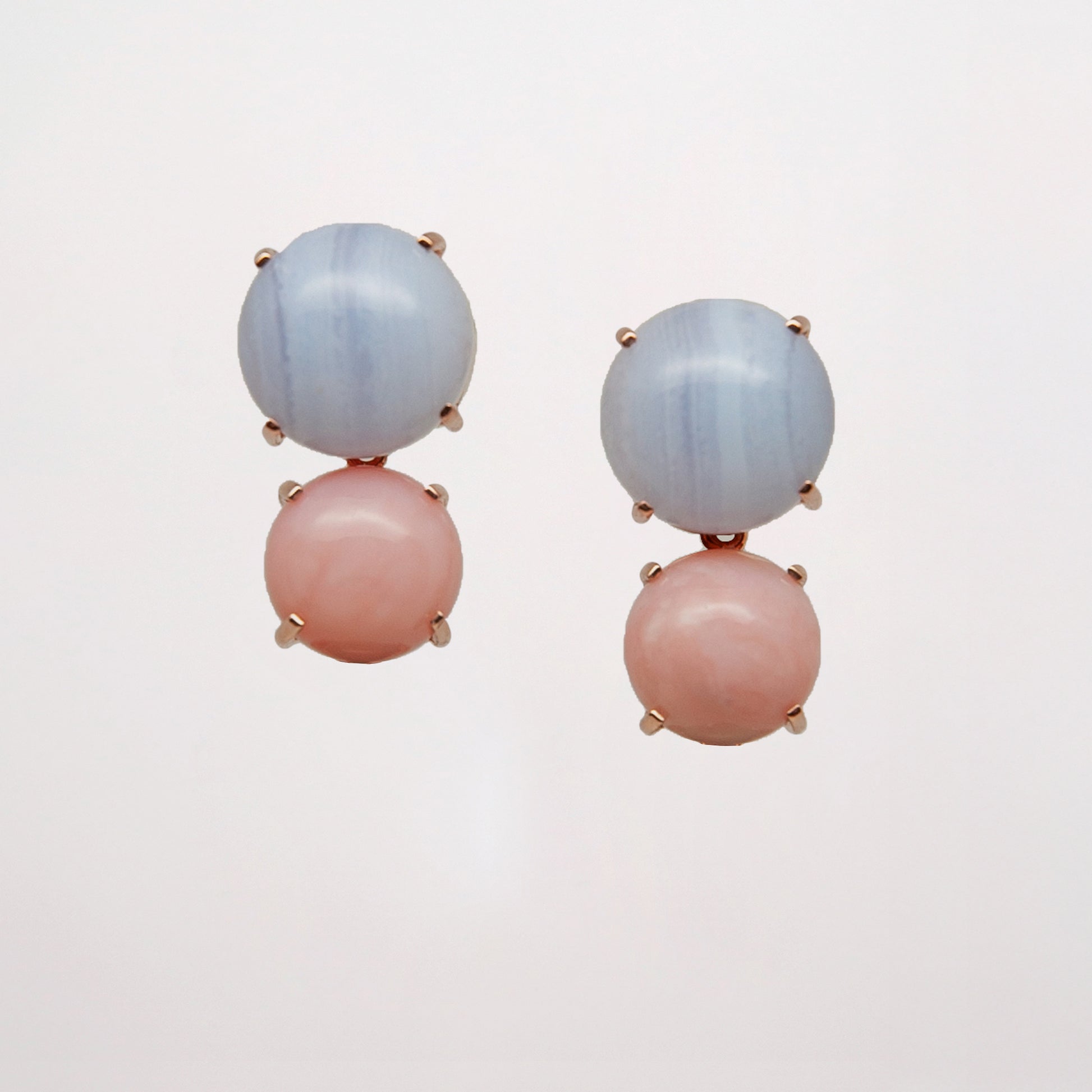 Chalcedony and Pink Opal as a pair of pink and blue gemstone earrings on white background set in rose gold