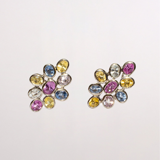 Pair of multicolored sahppire earrings on a light gray background