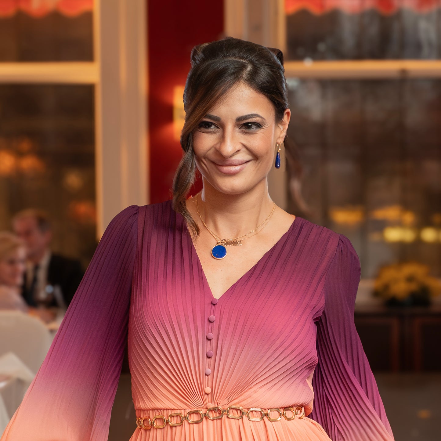 Model with elegant lapis lazuli earrings gold and pendant designed in Switzerland.