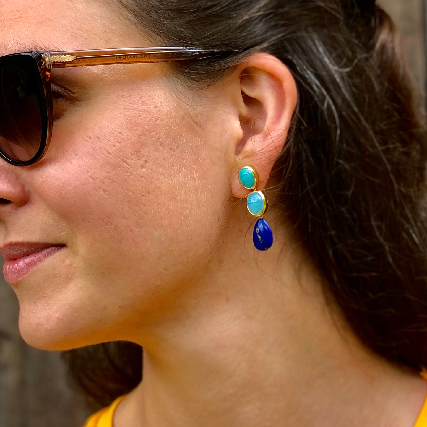 Pair of blue gemstone earrings with turquoise and blue stones on a model featuring Amazonite Studs, Chalcedony and Lapis Lazuli 